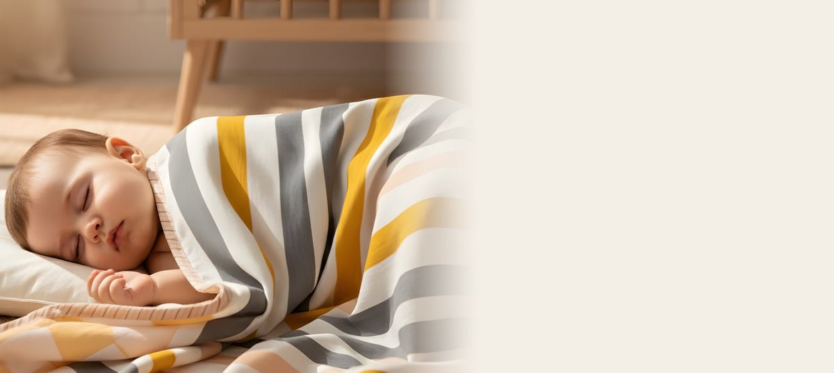 Baby sleeping under a striped mulmul quilt